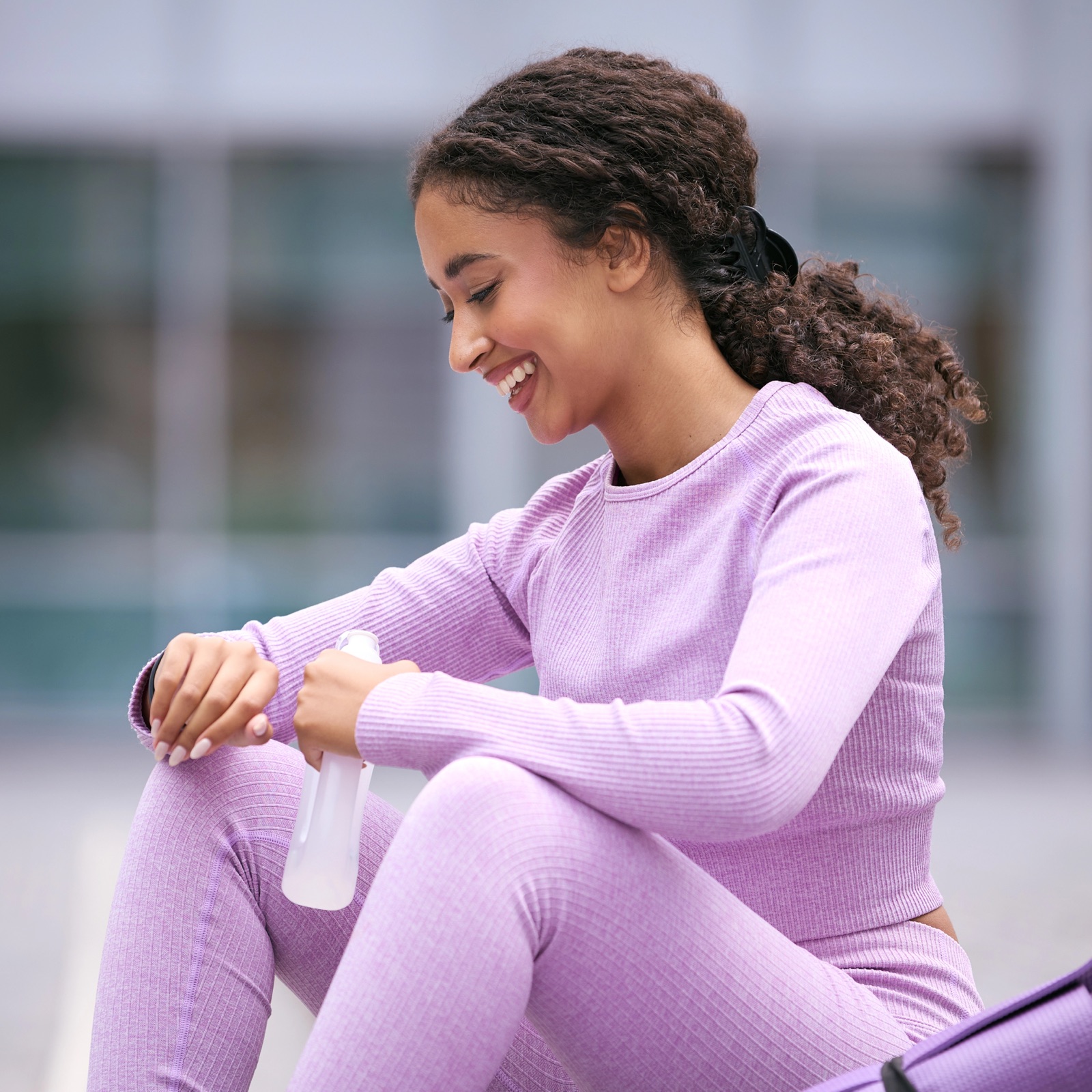 Person checking step count on Apple Watch while walking outdoors