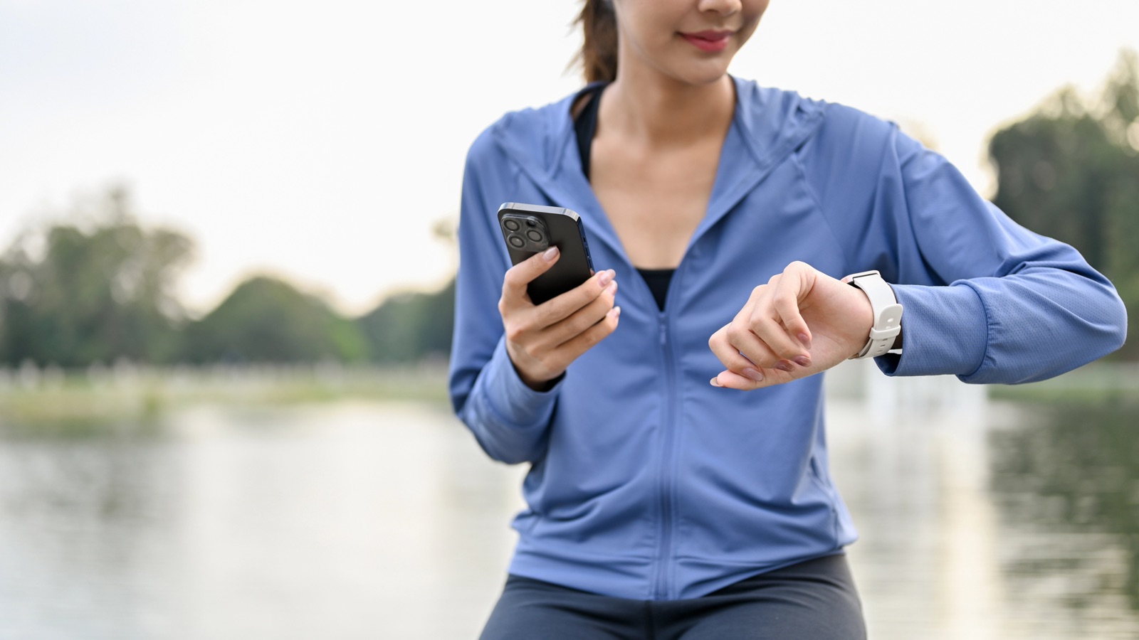 Sporty woman checking heart rate on smartwatch