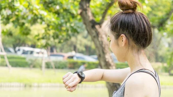 Person tracking fitness on a smartphone while walking outdoors