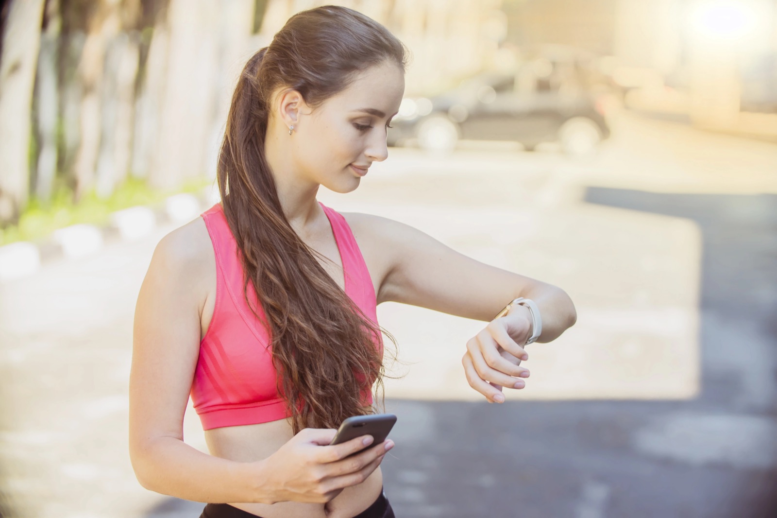 Person checking step count on smartwatch during outdoor walk