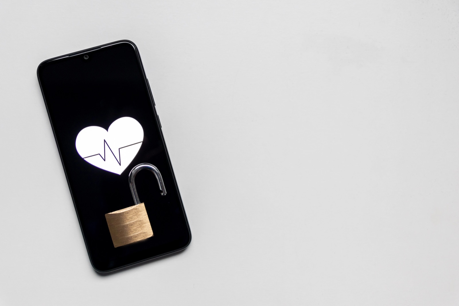 Mobile phone with heart and unlocked padlock representing data privacy