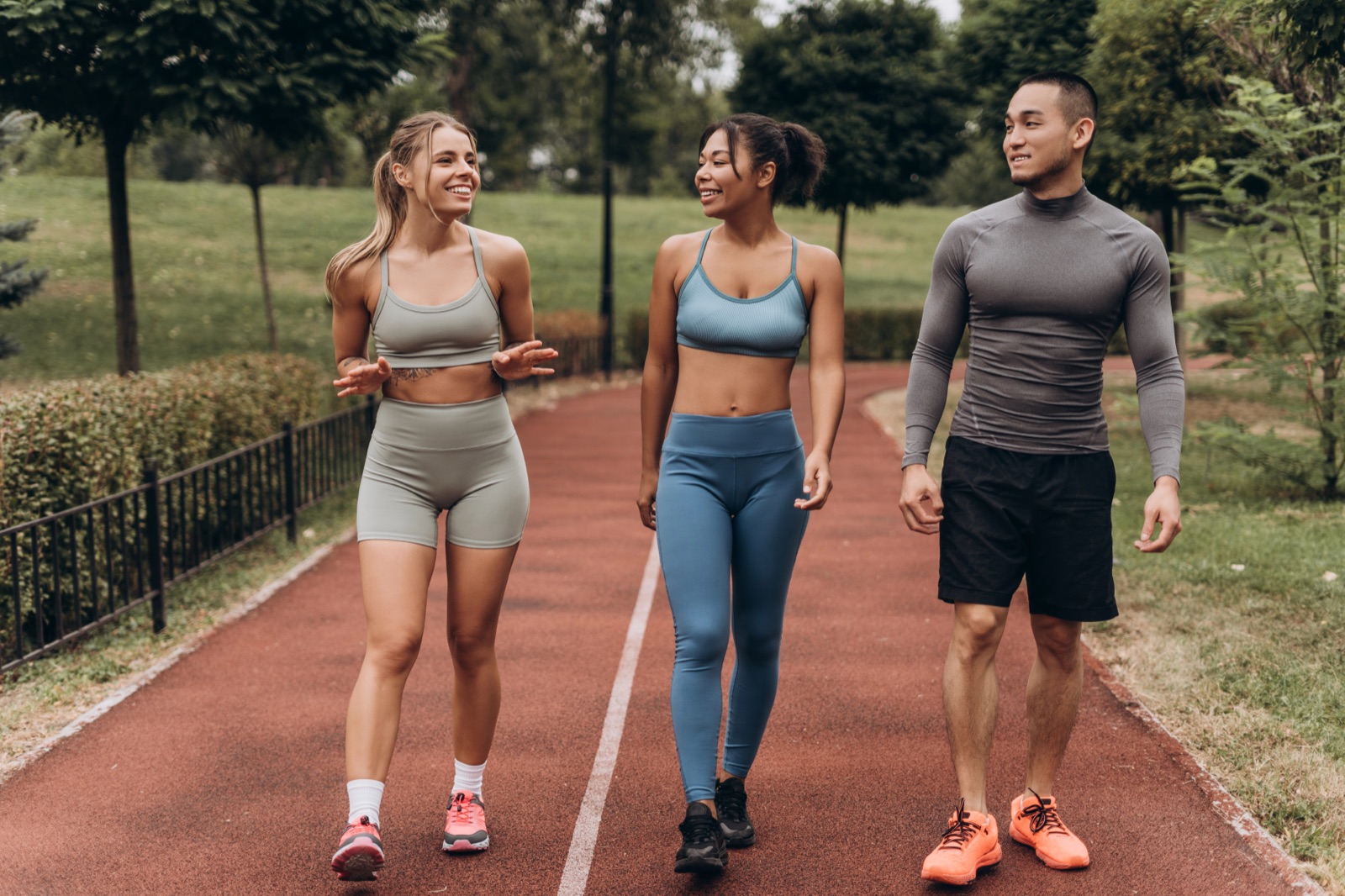 Diverse group of happy athletes walking outdoors