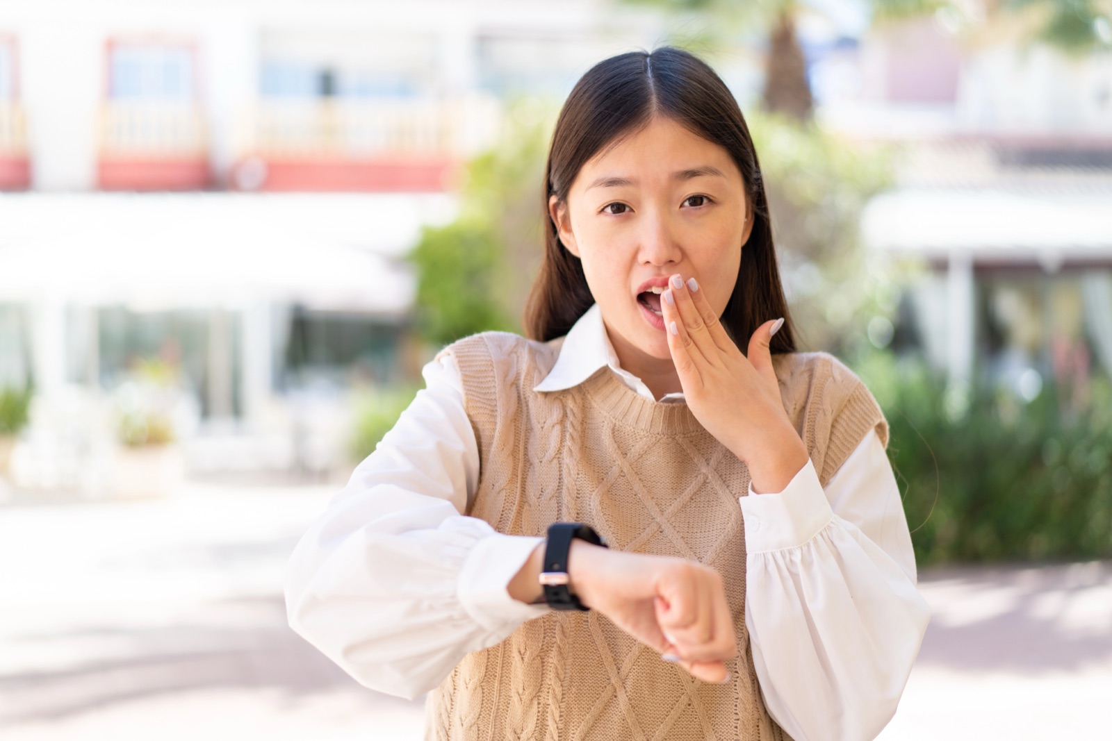 Woman looking at sport watch with concern
